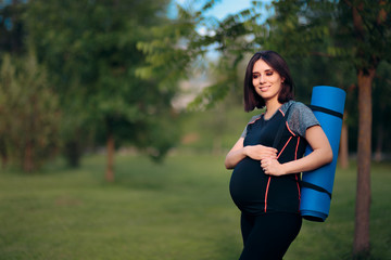 Happy Pregnant Woman with Yoga Mat Outdoors