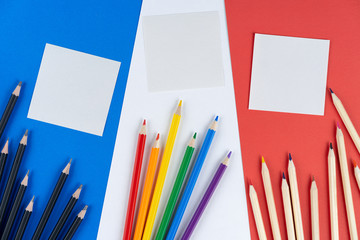 Lgbt colored, White, black pencils and two notes lie on flag France from texture colored cardboard. concept life of French lgbt community.