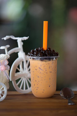 Ice bubble milk tea in takeaway glass.