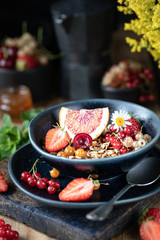 Homemade pumpkin muesli with nuts and seeds in a glass jar for a healthy breakfast. Autumn still life. Dark photo