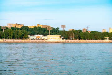 Naklejka premium View of the city of Khabarovsk from the Amur river. Urban landscape in the evening at sunset.