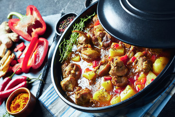 chicken curry in a black pan, top view