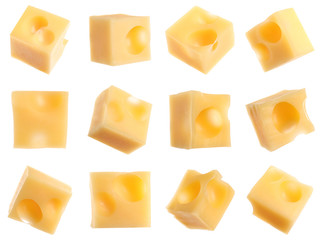 Set of delicious cheese cubes on white background