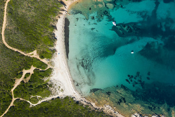 View from above, stunning aerial view of a wild beach bathed by a beautiful turquoise sea. (Emerald...