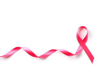 Pink awareness ribbon isolated on white background, top view