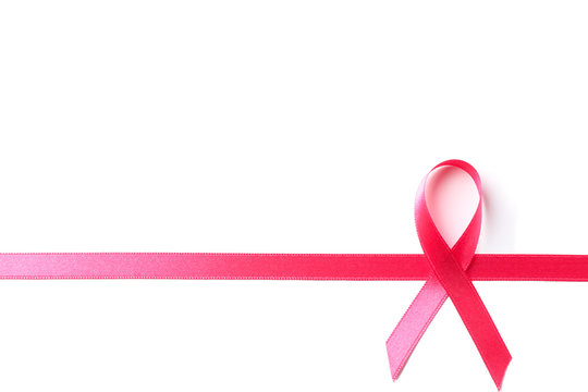 Pink awareness ribbon isolated on white background, top view