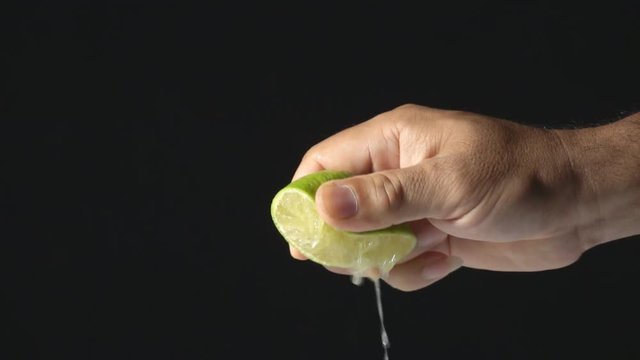 Hand squeeze lemon slow motion
