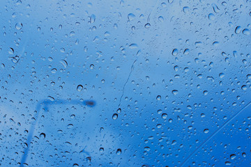 Water drops on glass natural bright background