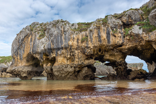 Natural arch of Cuevas del Mar beach, Asturias, Spain