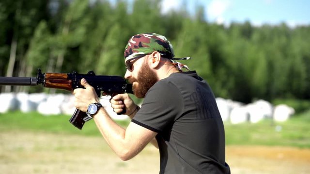 male shoots with a firearm, shotguns outdoors.