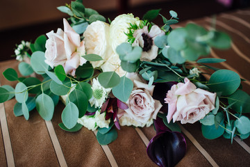Wedding asymmetrical stylish bouquet with purple roses