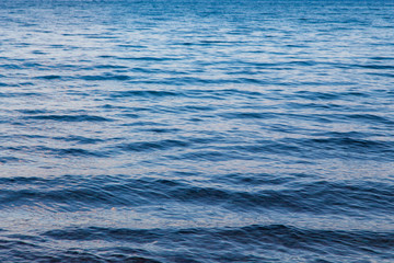 Naklejka na ściany i meble Blue clear water. Beautiful blue sea wave photograph close up. Beach vacation at sea or ocean.