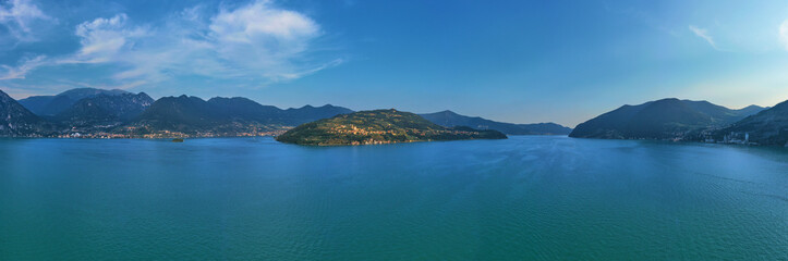 Fototapeta na wymiar Flying over the island of Monte on Lake Iseo north of Italy. Panoramic view of the alps. A good place to rest in travel.