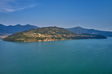 Flying over the island of Monte on Lake Iseo north of Italy. Panoramic view of the alps. A good place to rest in travel.