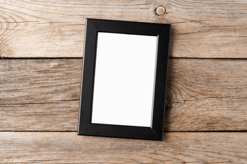 Picture frame with copyspace on wooden background