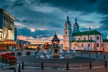 Fototapeta premium Minsk, Belarus. Illuminated Cathedral Of Holy Spirit In Minsk At Evening Or Night Street Lights . Famous Landmark. Main Orthodox Church Of Belarus At Evening.