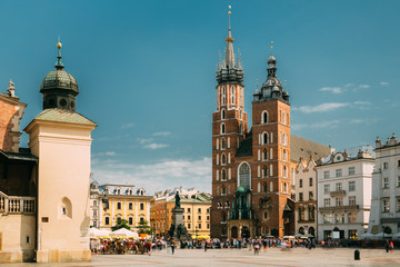 Fototapeta na wymiar Krakow, Poland. Cloth Hall Building And St. Mary's Basilica. Famous Old Landmark Church Of Our Lady Assumed Into Heaven. Saint Mary's Church. UNESCO World Heritage Site