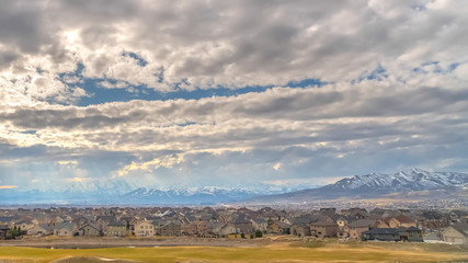 Panorama Panoramic view of cloud filled blue sky over houses on a vast valley