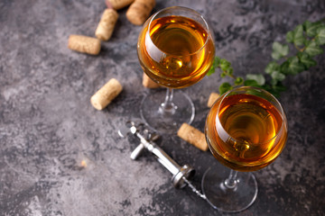 Two glasses with white wine on a textural background. Copy space. Place for your text.