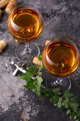 Two glasses with white wine on a textural background. Copy space. Place for your text.