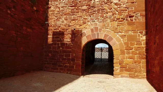 The entrance to the Castle of Silves, in The Algarve, Portugal, with its distinctive red sandstone and history dating back to 201 BC