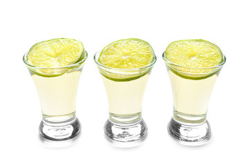 Shots of tequila on white background