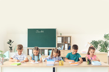 Pupils passing school test in classroom