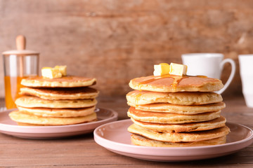 Fototapeta na wymiar Tasty pancakes with butter on wooden table