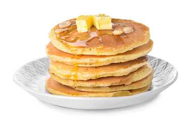 Tasty pancakes with butter on white background