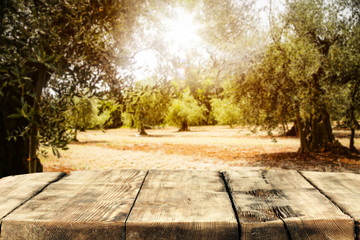 Table background and autumn time. Sunny garden in blurred view in distance. Empty space for decoration and an advertising product.