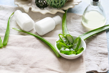Composition with aloe vera and cosmetics on table