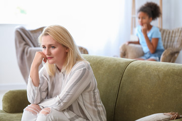 Sad woman after quarrel with daughter at home
