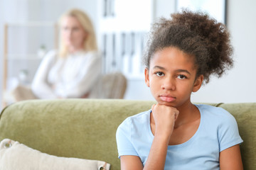 Offended African-American girl after quarrel with mother at home