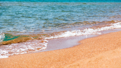 sandy beach and blue sea wave. Beautiful natural background.