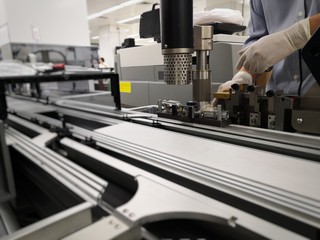 Technician is checking the equipment and maintenance of conveyor for the delivery of blood vessels at the Pathology department.
