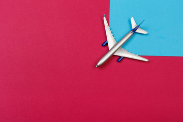 top view photo of toy airplane over color  background . travel concept .