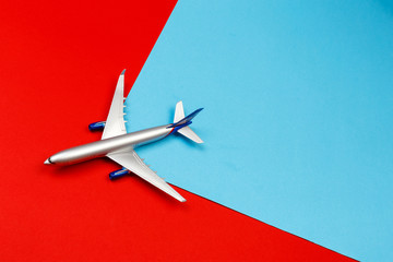 top view photo of toy airplane over color  background . travel concept .