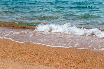 sandy beach and blue sea wave. Beautiful natural background.