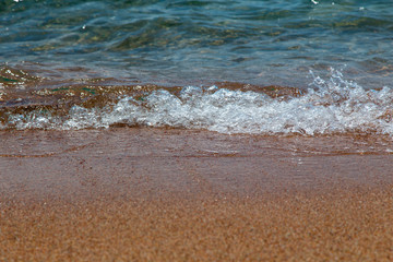Fototapeta na wymiar sandy beach and blue sea wave. Beautiful natural background.