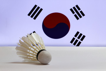 Used shuttlecocks on white floor with South Korea flag background. Concept of Badminton.