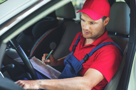 vehicle technical inspection - man sitting inside the car and checking dashboard