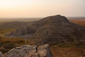 view from the top of the mountain at sunset against the backdrop of the mountains in the fog.