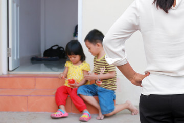 Mother scolds her child because of playing naughty and refusing to obey