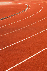 athletic red running tracks whit white lines..