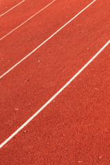 closeup of athletic red running tracks whit white lines