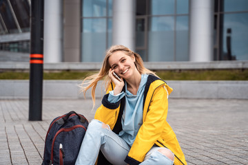 Fototapeta premium Beautiful girl calls by phone and sits on skateboard.