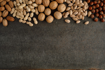frame made of different types of nuts on stone background