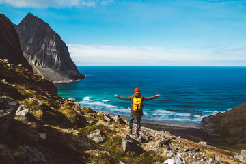 Man stand on cliff edge alone enjoying aerial view backpacking lifestyle travel adventure outdoor vacations