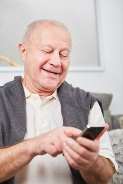 Senior citizen writing a message or SMS