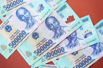 Five hundred thousand dong banknotes on a brown background close-up. Vietnamese money